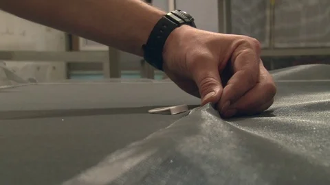 The wizard inserts the mosquito net in the frame for the window Stock Footage 75156589