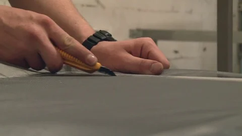 The wizard inserts the mosquito net in the frame for the window Stock Footage 75156756