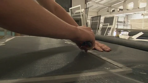 The wizard inserts the mosquito net in the frame for the window Stock Footage 75156988