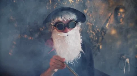 Wizard Merlin conjures and casts a spell, raising his wand, a old man Stock Footage 68846900