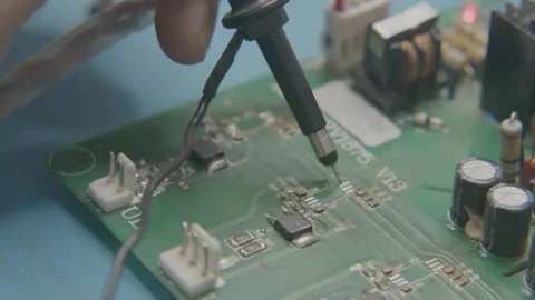 The wizard uses an electronic tester to test the components on the computer Stock Footage 246197841