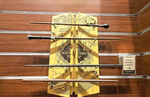 Wizarding wands displayed with Marauder's Map in magical shop setting Stock Photos