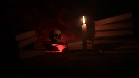 Wizard's Desk.  A human skull, old books and candle Stock Footage 89185010