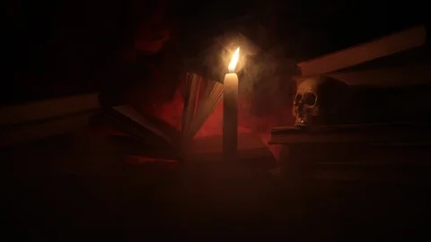 Wizard's Desk.  A human skull, old books and candle Stock Footage 89185059