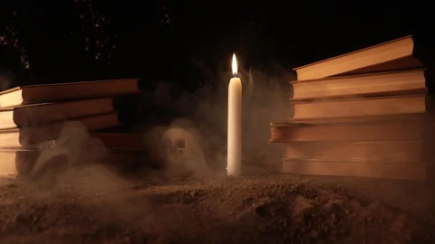 Wizard's Desk.  A human skull, old books and candle Stock Footage 89185130