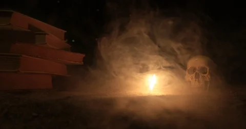 Wizard's Desk.  A human skull, old books and candle Stock Footage 89185313