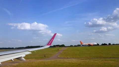 Wizzair plane approaches the runway while another plane lands. Stock Footage 131749183