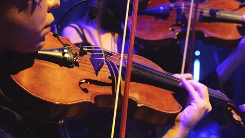 Wo violinists performing on stage under blue concert lighting Video stock 301643238