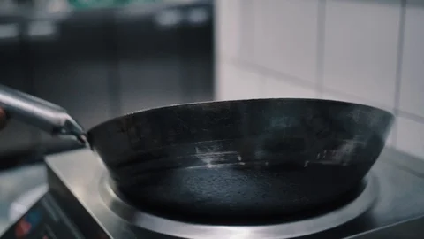 The wok pan with butter warms up Stock-Footage 112586796