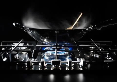 Wok pan on the flame Stock Photos