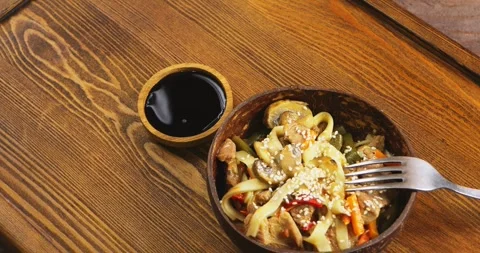 Wok udon with beef and vegetables in a plate sprinkled with sesame seeds ne.. Stock Footage 264521497