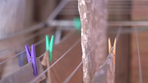 Woma doing laundry hanging clothes do housekeeping 库存影片 265478625