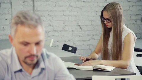 Womam from back view is chatting with man at office using smartphone. Stock Footage 109414093