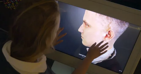 Womam looking at 3D human model on touchscreen monitor Video stock 52444008