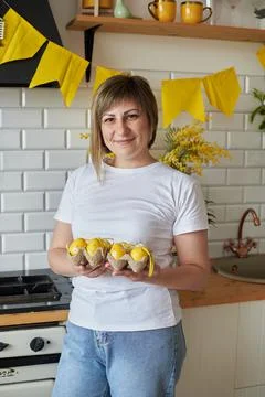 Woman 37 years old with Easter eggs in the kitchen Stock Photos