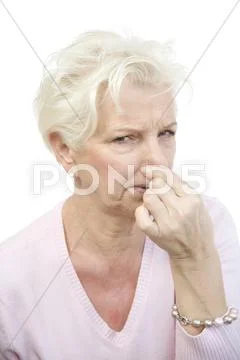 Woman, 60, holding her nose in disgust Stock Photos