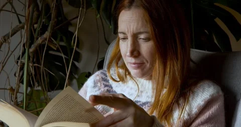 Woman absorbed in deep reading Stock Footage 325779470