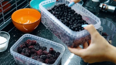 The woman adding the blueberrys	 Stock Footage 116765693