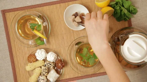 Woman adding brown sugar to tea 库存影片 3357990