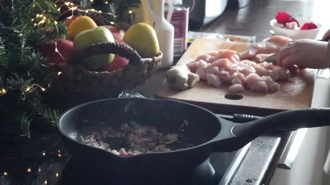 Woman adding chopped chicken to the pan with onions Stock Footage 137551936