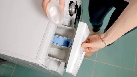 Woman adding detergent to compartment in washing machine and closing drawer Stock Footage 85333182