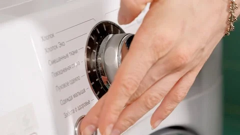 Woman adding detergent to compartment in washing machine and closing drawer Stock Footage 85333356