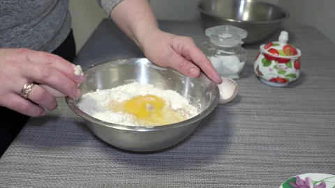 Woman Adding Egg To Flour 스톡 동영상 270284256