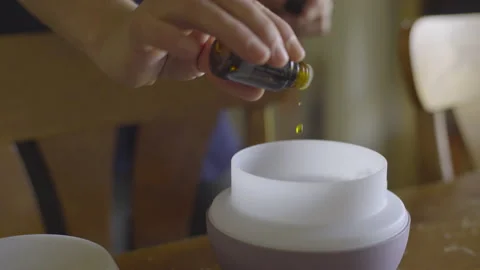 Woman Adding Essential Oil to Diffuser Video stock 208724399