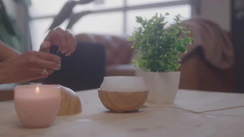 Woman Adding Essential Oils to a Diffuser at Home During the Daytime Video stock 208802683