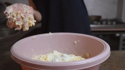 Woman adding flour and kneading dough in a pink bowl 스톡 동영상 336640272