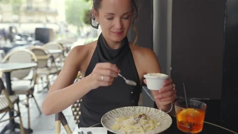 Woman Adding Grated Cheese to Pasta at Paris Sidewalk Cafe Stock Footage 344960558