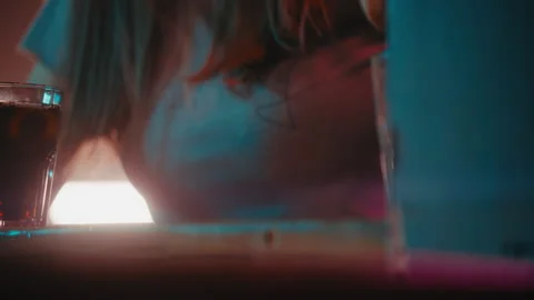 Woman adding ice cubes to a soft drink Stock Footage 275303503