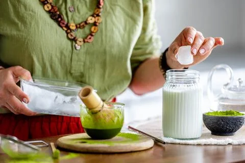 Woman Adding Ice To Matcha Latte Stock Photos