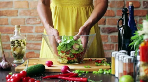 Woman adding lettuce to the vegetable salad, closeup Stock Footage 40544446