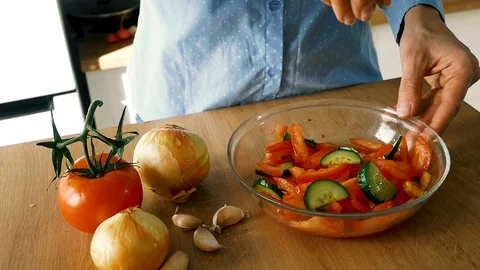Woman adding salt in salad with vegetables in glass bowl, slow motion video Stock Footage 108928290