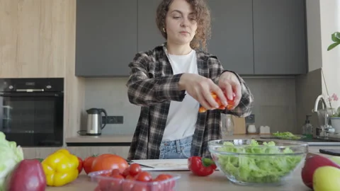 Woman Adding Sliced Tomato To Fresh Healthy Salad Stock Footage 344698229