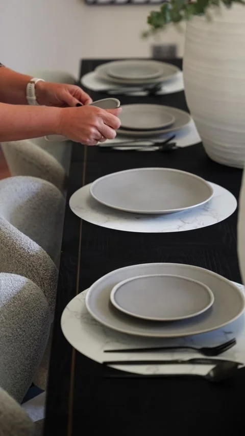 Woman Adds Final Touch to Elegantly Staged Dining Table for Guests Stock-Footage 327428052