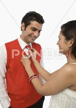Woman adjusting her boyfriend's tie Stock Photos
