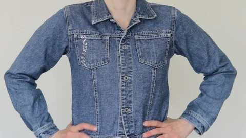A Woman Adjusts A Denim Jacket. Stock Footage 129624262
