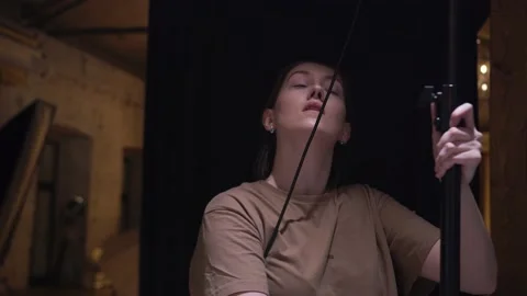 A woman adjusts a light device on the set. Professional content creation Stock Footage 148105170