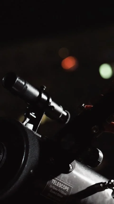 Woman adjusts optical device labeled Telescope D76mm F700mm Coated Optics Made Stock Footage 343077698