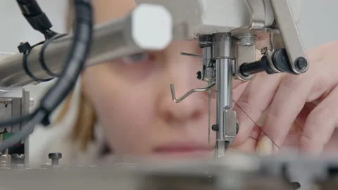 The woman adjusts the thread on the sewing machine Stock-Footage 159413816