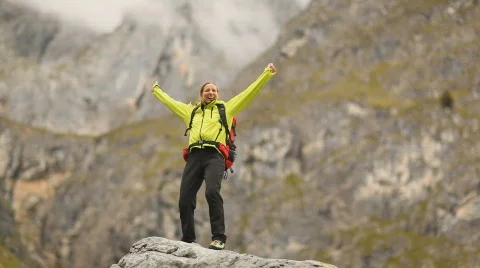 Woman after reaching mountaintop Stock Footage