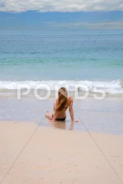 Woman Alone Sit On The Beach Looking Sea And Island.