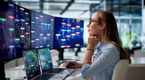 Woman Analyst Studies Automated Workflow Data On Laptop For Business Improvem Stock Photos