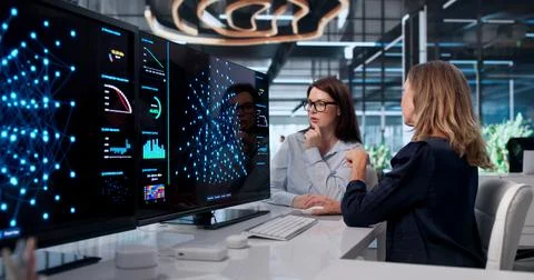 Woman Analyzes AI Software Data On Computer For Predictive Analytics Project. Stock Photos