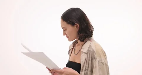 Woman analyzes documents trying to understand instructions Stock Footage 289326949