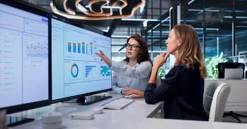 Woman Analyzes Financial Data On Computer To Improve Invoice Workflow. Stock Photos