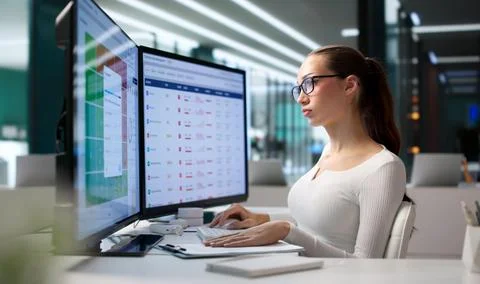 Woman Analyzes Vendor Data On Computer For Compliance And Risk Management Tas Stock Photos