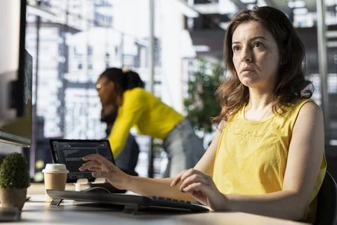 Woman analyzing data on computer in office Foto stock